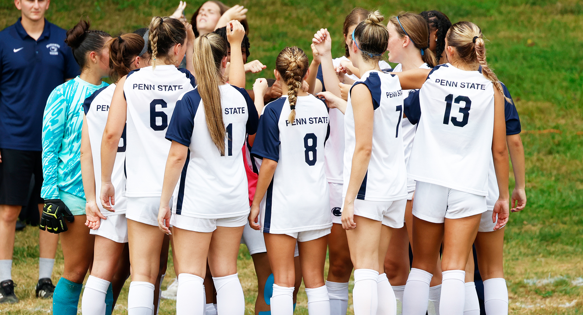 women's soccer players huddle pre-game
