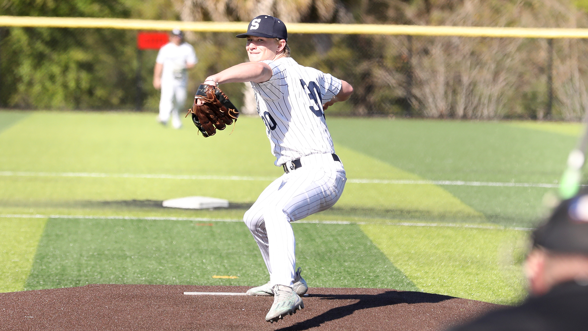 baseball pitcher throwing a pitch