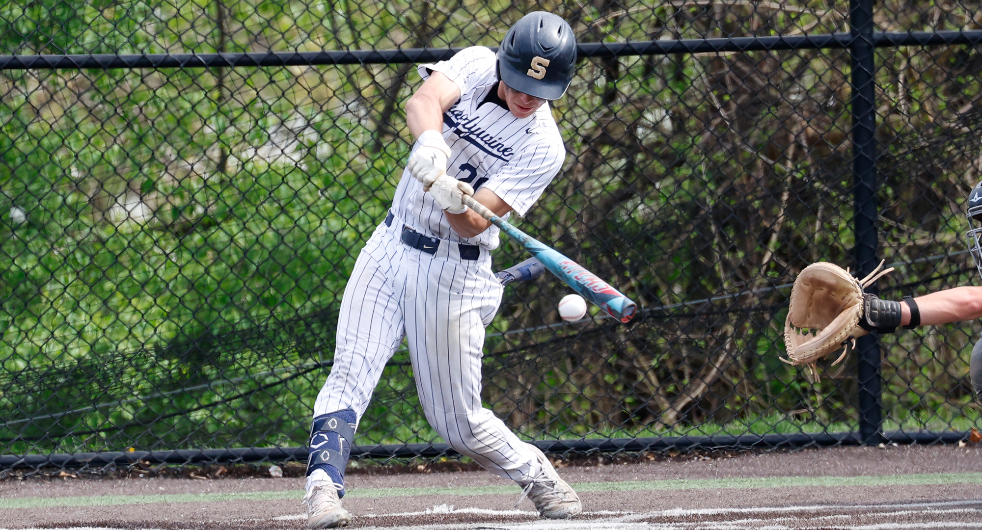 baseball player makes contact with ball
