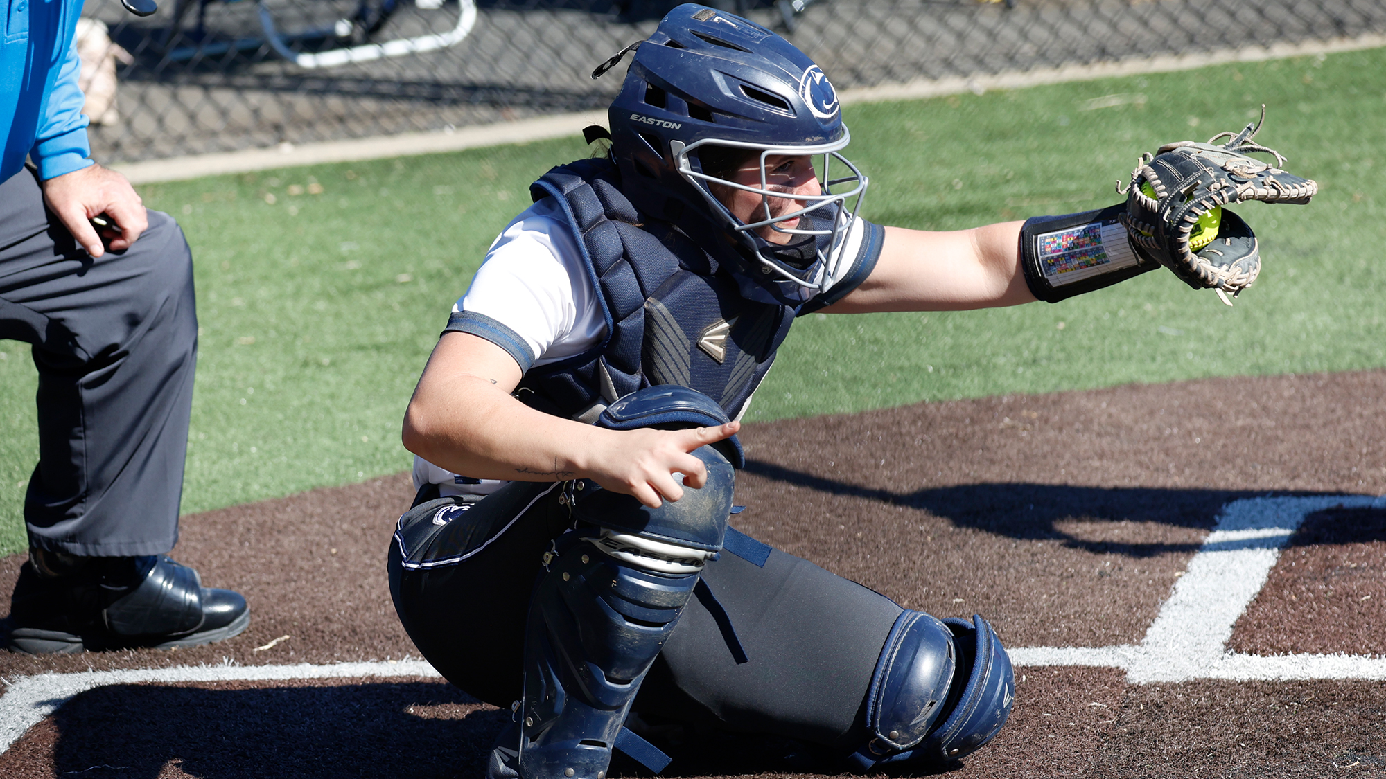 Softball catcher receiving pitch
