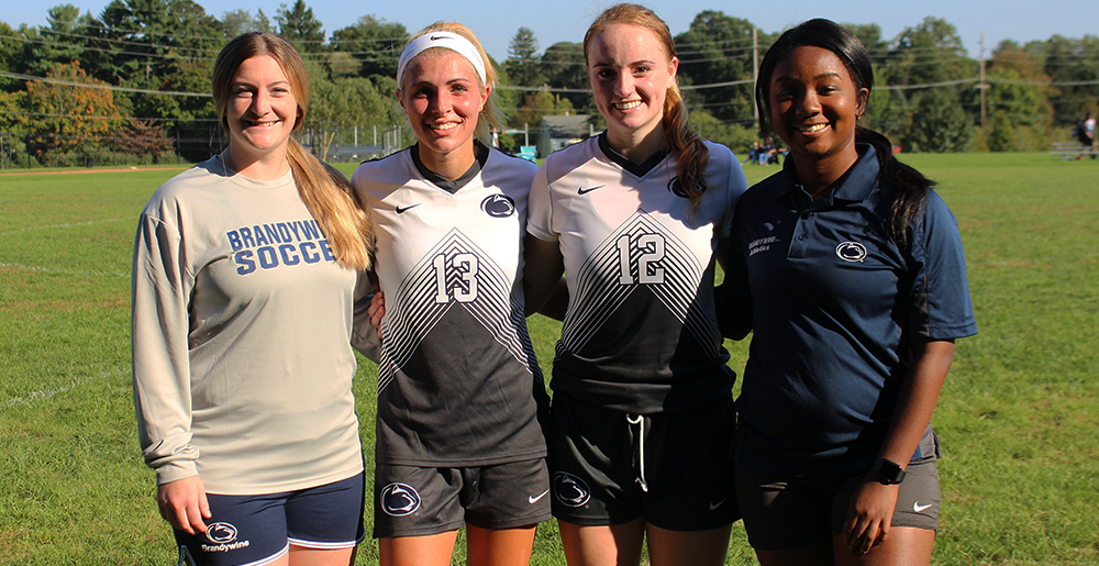 2018 seniors Arianna Segich and Amanda Roy with coaches Maxine New and Elise Pratt