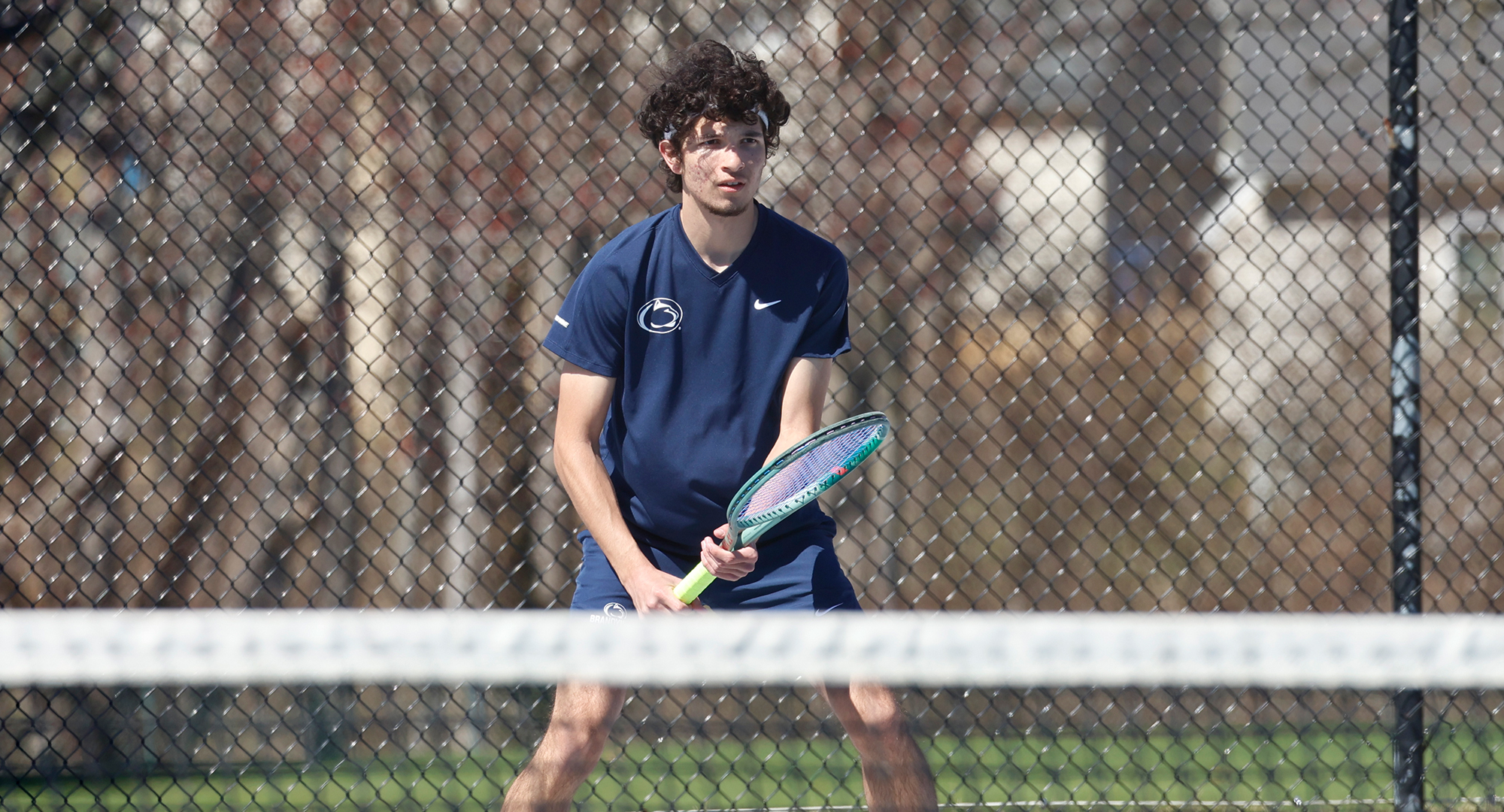 men's tennis player readies for serve